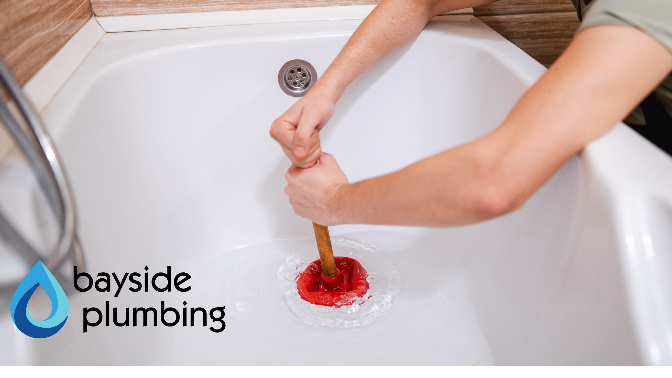 Plumber using a plunger to unclog a bathtub drain in Spanish Fort, AL.